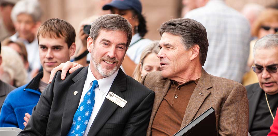 Joe Pojman Ph.D. sitting with Rick Perry at the March for Life
